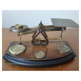 intage brass and wood balance scale marked "Warranted Accurate" with integrated brass weights on a w
