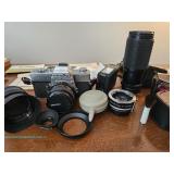 Minolta SR-T 102 35mm film camera with multiple Minolta and Spiratone lenses, flash units, accessori