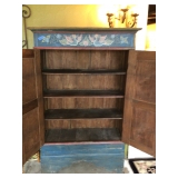 Inside folk art armoire 