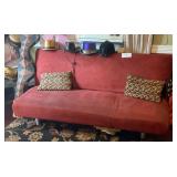 Red sofa folds back into a bed