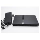 Black Video Game Console with Power Adapter
