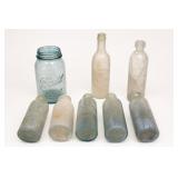 Assorted Clear and Blue Glass Bottles and Jar