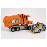 Two Toy Trucks Including Orange Garbage Truck