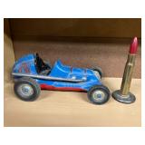 Toy racecar, bullet paperweight