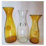 FHM082 - Three Vintage Glass Wine Carafes / Paul Masson Since 1852 & Amber Embossed Seal Decanters