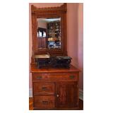 Antique oak washstand cabinet with slanting mirror.