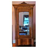 Antique Carved Tiger Oak Armoire Wardrobe Cabinet with Large Mirrored Door.