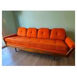 MCM Adrian Pearsall-style Gondola Sofa in Vibrant Textured Orange Fabric with Walnut Wood Accents.