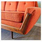 MCM Adrian Pearsall-style Gondola Sofa in Vibrant Textured Orange Fabric with Walnut Wood Accents.