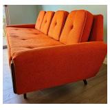 MCM Adrian Pearsall-style Gondola Sofa in Vibrant Textured Orange Fabric with Walnut Wood Accents.