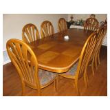 Large dinning table w/2 leafs, 8 chairs and pad for $300