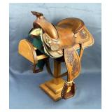 Sanders Saddlery Mini Horse Saddle With Oak Leaf And Acorn Stamping, Includes Blanket And Wood Stand Sanders Saddlery Mini Horse Saddle With Oak Leaf And Acorn Stamping, Includes Blanket And Wood Stand