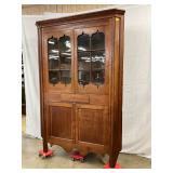 Glass eight-pane doors, drawer, shaped apron, and bracket feet 