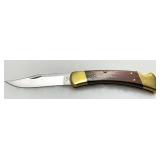 Buck Model 110 Folding Knife with Brass Bolsters and Wood Handle Buck Model 110 Folding Knife with Brass Bolsters and Wood Handle