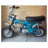 Equipped with a 4-stroke engine, manual kick-start, and rear shocks