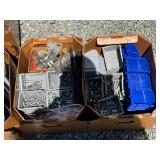 Assorted hardware items including screws, bolts, nuts, plastic storage bins, and additional fastener