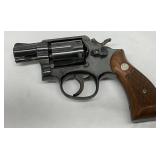 blued finish, a 2-inch barrel, and original wooden grips with medallion detail blued finish, a 2-inch barrel, and original wooden grips with medallion detail