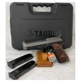 featuring a stainless steel slide and a black alloy frame, wooden grip panels