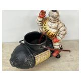 Cast Iron Michelin Man Figurine Sitting on a Bomb-Shaped Object, Replica 