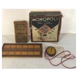 K - Vintage Game and Book Collection Including Monopoly, Cribbage Board, Compass, and Poor Richard