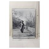 Black and White Photograph of a Boy Walking Down a Country Lane with Fishing Pole Over His Shoulder - with Frame