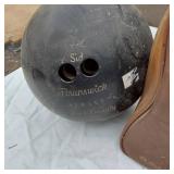 Vintage sports equipment lot including Brunswick Black Beauty and AXIS bowling balls, Pogo stick, hockey sticks, and additional items.