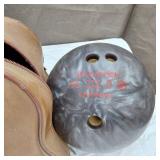 Vintage sports equipment lot including Brunswick Black Beauty and AXIS bowling balls, Pogo stick, hockey sticks, and additional items.