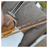 Vintage sports equipment lot including Brunswick Black Beauty and AXIS bowling balls, Pogo stick, hockey sticks, and additional items.
