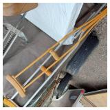 Vintage sports equipment lot including Brunswick Black Beauty and AXIS bowling balls, Pogo stick, hockey sticks, and additional items.