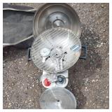 Solar panel with camping gear including BBQ grill, cot, and table
