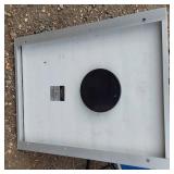 Solar panel with camping gear including BBQ grill, cot, and table