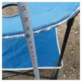 Solar panel with camping gear including BBQ grill, cot, and table