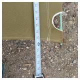 Solar panel with camping gear including BBQ grill, cot, and table