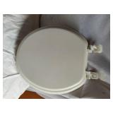 Assorted Plumbing Supplies and Tools including Drill Powered Drain Auger, Toilet Seat, and Various Fittings