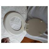 Assorted Plumbing Supplies and Tools including Drill Powered Drain Auger, Toilet Seat, and Various Fittings