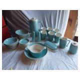 Mid-century modern dinnerware set including bowls, cups, pitchers, and serving pieces