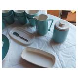 Mid-century modern dinnerware set including bowls, cups, pitchers, and serving pieces