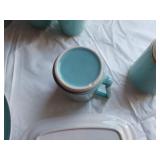 Mid-century modern dinnerware set including bowls, cups, pitchers, and serving pieces
