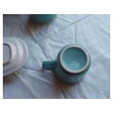 Mid-century modern dinnerware set including bowls, cups, pitchers, and serving pieces