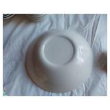 Mid-century modern dinnerware set including bowls, cups, pitchers, and serving pieces
