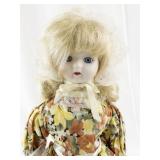 Vintage Porcelain Doll with Blonde Hair and Floral Dress