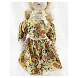 Vintage Porcelain Doll with Blonde Hair and Floral Dress