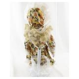Vintage Porcelain Doll with Blonde Hair and Floral Dress