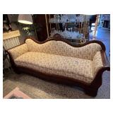 Antique Victorian-Style Sofa with Carved Wood Detail and Floral Upholstery