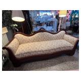Antique Victorian-Style Sofa with Carved Wood Detail and Floral Upholstery