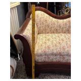 Antique Victorian-Style Sofa with Carved Wood Detail and Floral Upholstery
