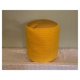 Yellow Fabric Ottoman and Green Sleeping Bag with Stuff Sack
