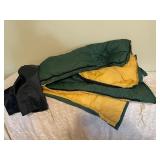 Yellow Fabric Ottoman and Green Sleeping Bag with Stuff Sack