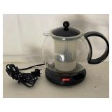 Collection of Kitchen Items Including Hammered Metal Ice Bucket, Glass Vase, and Bodum Electric Teapot