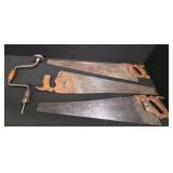 Antique tools. 3 vintage hand saws and 1 ratcheting brace drill